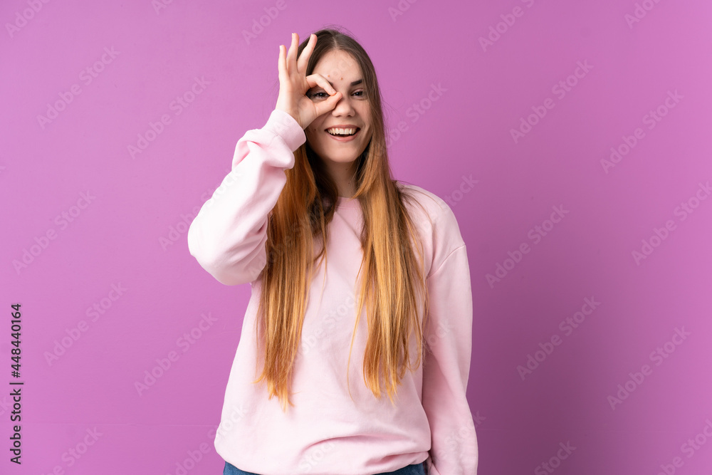 Young caucasian woman isolated on purple background showing ok sign with fingers Young caucasian woman isolated on purple background showing ok sign with fingers