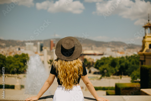 Canvas Print A beautiful girl stands against the background of Barcelona and enjoys the journey