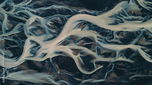 A glacial rivers from above. Aerial photograph of the river streams from Icelandic glaciers. Beautiful art of the Mother nature created in Iceland. Wallpaper background high quality photo.