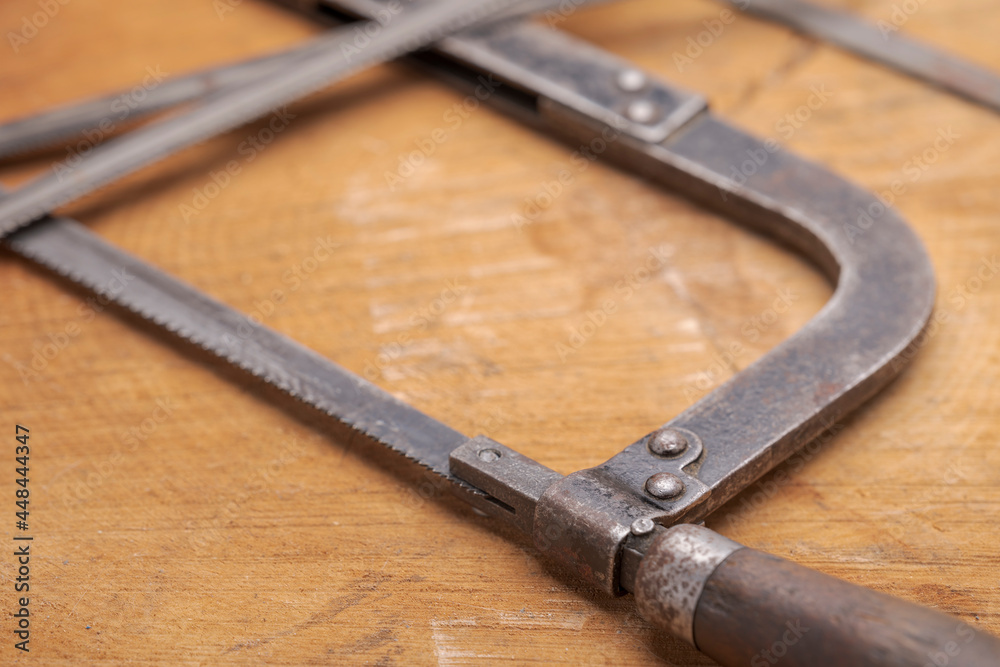 Obraz premium Old vintage metal hacksaw blade close up. Background for craftsmanship and manual labor.