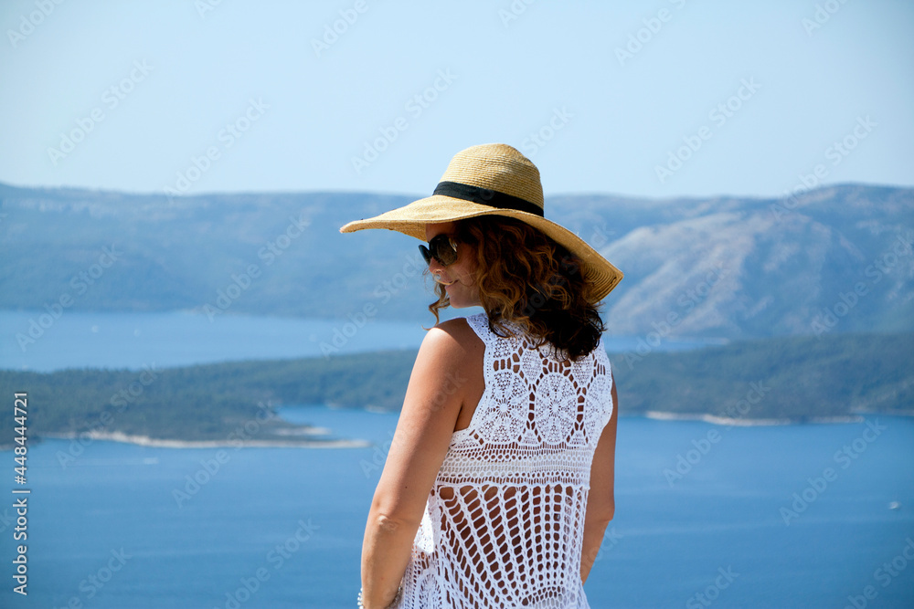 Woman in white lace dress viewing the Adriatic sea
