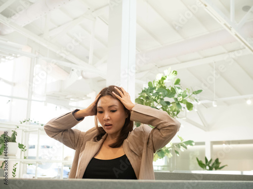 businesswoman female wear brown suit finger hand catch headache feeling job career economy business crisis worry depression problem bad company office work from home covid-19 corona virus pandemic photo