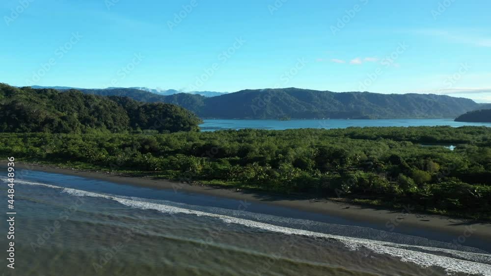 Golfito bay aerial view mountains with rainforest and empty wild beach Costa Rica aerial sunny day Golfito bay aerial view mountains with rainforest and empty wild beach Costa Rica aerial sunny day