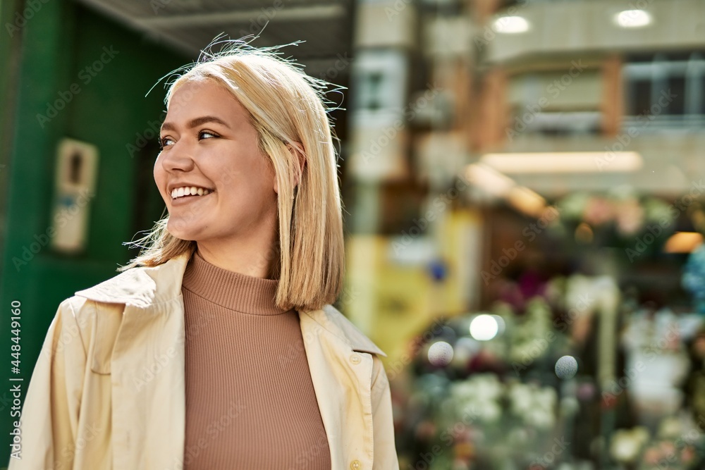 Fototapeta premium Young blonde girl smiling happy standing at the city.
