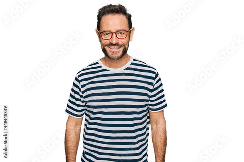 Middle age man wearing casual clothes and glasses with a happy and cool smile on face. lucky person.