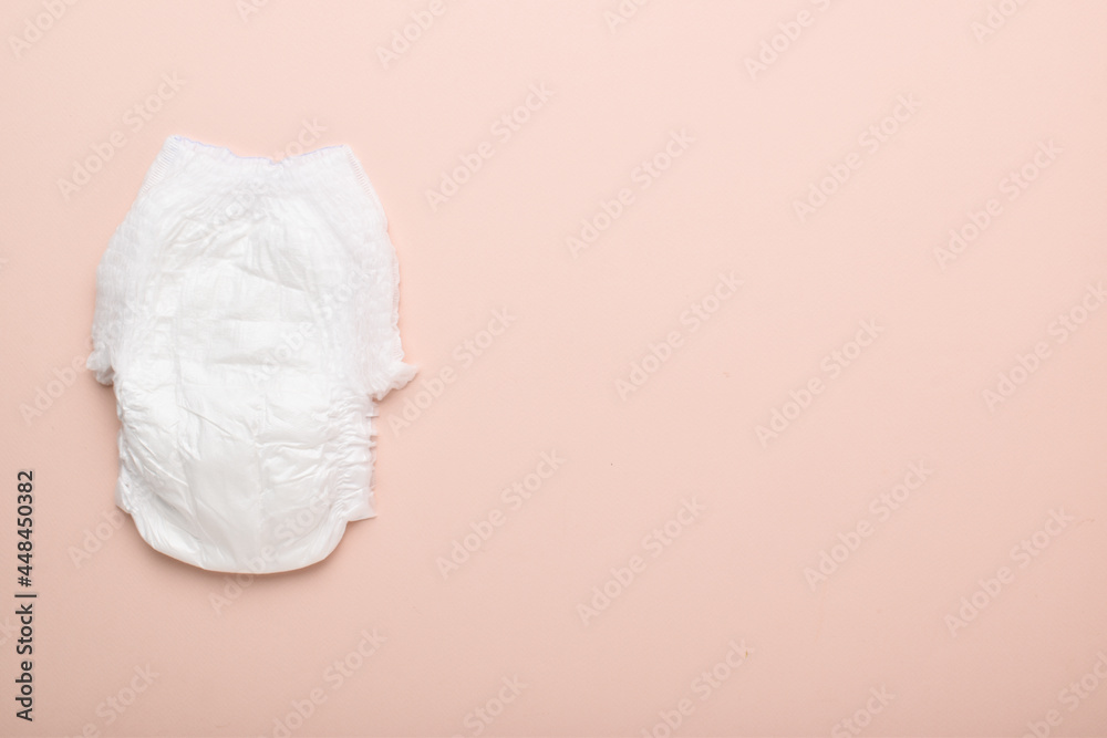 One diaper, disposable panties on a pink background with a place to copy. One diaper, disposable panties on a pink background with a place to copy.