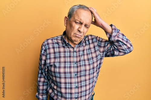 Handsome senior man with grey hair wearing casual shirt confuse and wonder about question. uncertain with doubt, thinking with hand on head. pensive concept. © Krakenimages.com