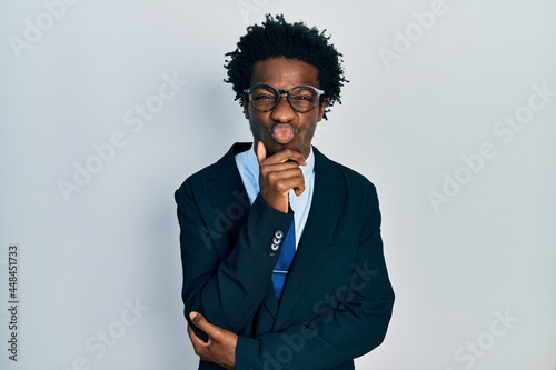 Young african american man wearing business suit and tie looking at the camera blowing a kiss being lovely and sexy. love expression.