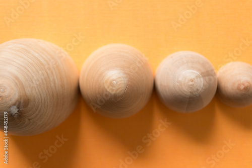 egg-shaped wooden objects on yoke yellow background