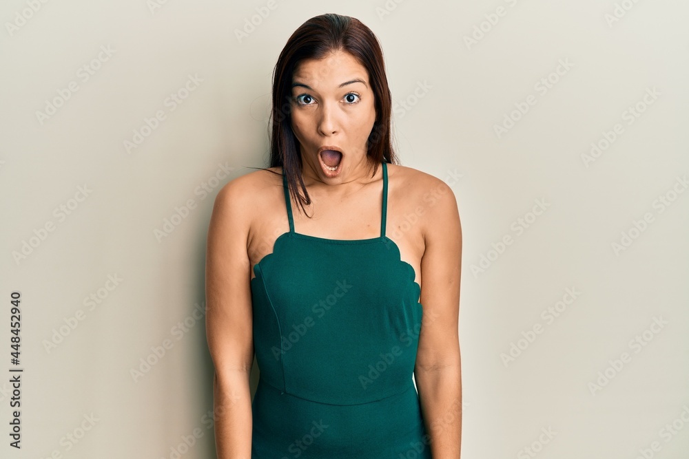 Young latin woman wearing casual clothes scared and amazed with open mouth for surprise, disbelief face Young latin woman wearing casual clothes scared and amazed with open mouth for surprise, disbelief face