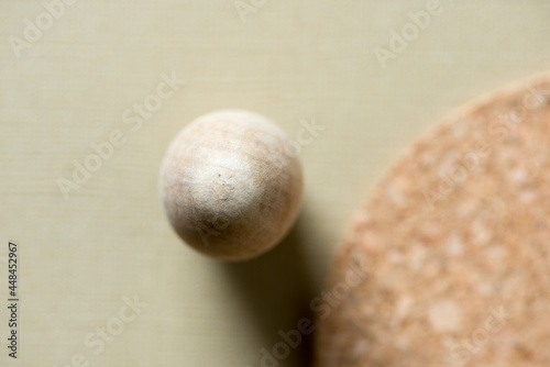 wooden object with out of focus cork coaster on light beige background 