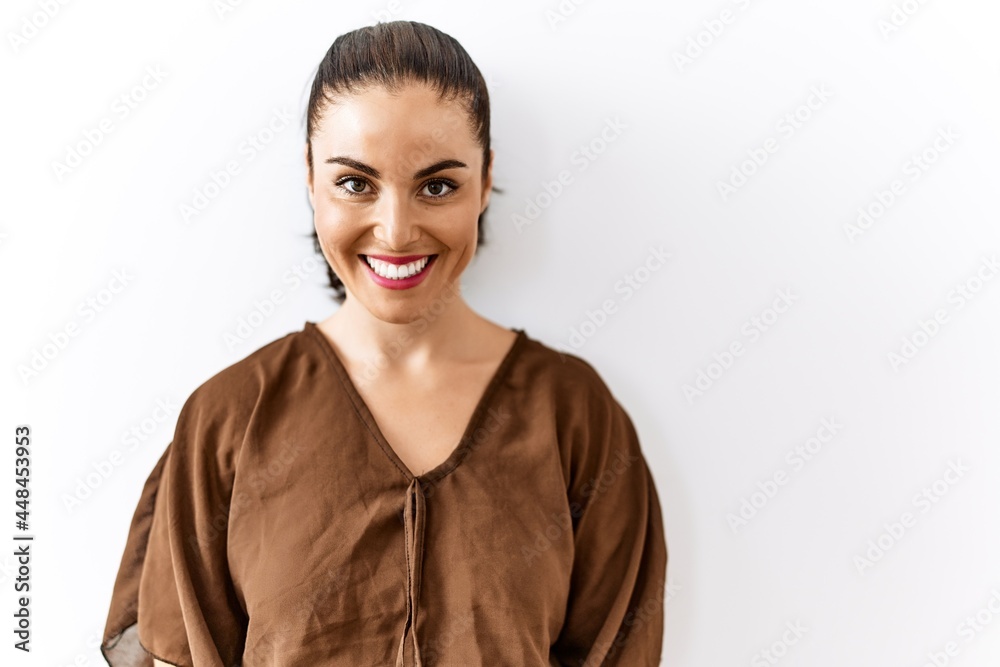 Young brunette woman standing over isolated background with a happy and cool smile on face. lucky person. Young brunette woman standing over isolated background with a happy and cool smile on face. lucky person.