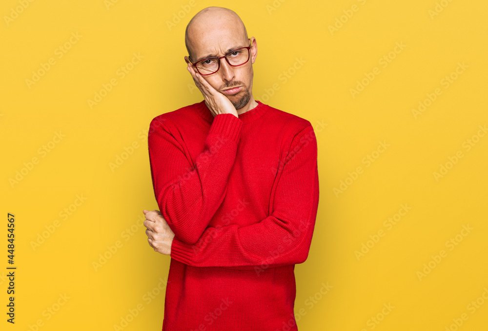 Bald man with beard wearing casual clothes and glasses thinking looking tired and bored with depression problems with crossed arms. Bald man with beard wearing casual clothes and glasses thinking looking tired and bored with depression problems with crossed arms.