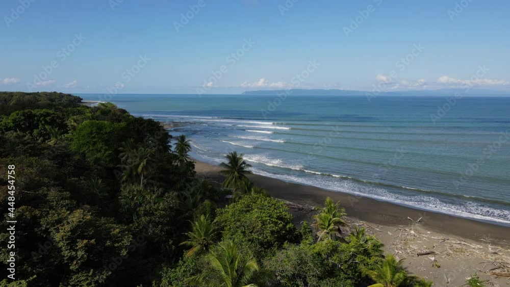 Amazing perfect small waves in tropical environment Costa Rica sunny day drone shot Amazing perfect small waves in tropical environment Costa Rica sunny day drone shot