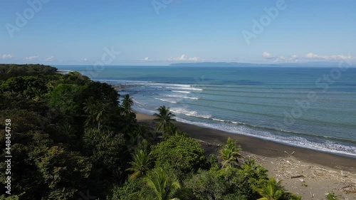 Amazing perfect small waves in tropical environment Costa Rica sunny day drone shot photo