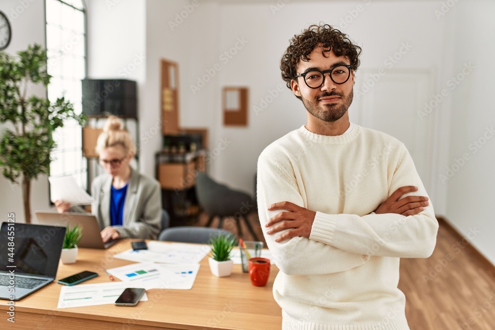 Businessman smiling happy with arms crossed gesture standing at the office. Businessman smiling happy with arms crossed gesture standing at the office.