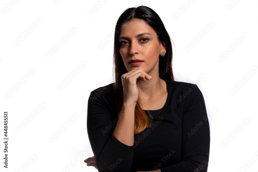 Young business latina woman isolated against a white background confident, touching chin with hand. Young business latina woman isolated against a white background confident, touching chin with hand.