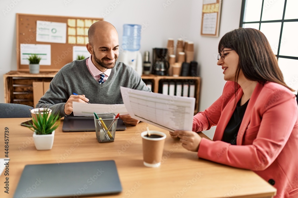 Two hispanic business workers smiling happy working at the office. Two hispanic business workers smiling happy working at the office.