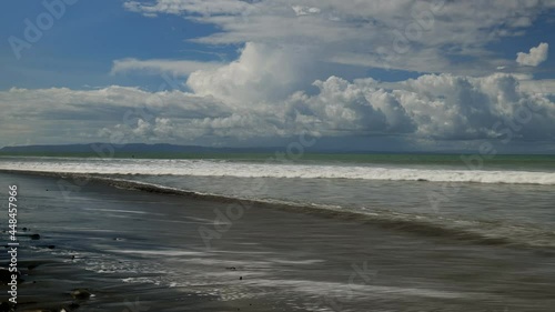 Time lapse of waves with surfers Golfe dulce pavones Costa Rica Corcovado in background photo