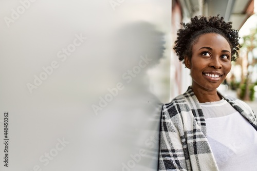 Young african american girl smiling happy standing at the city.