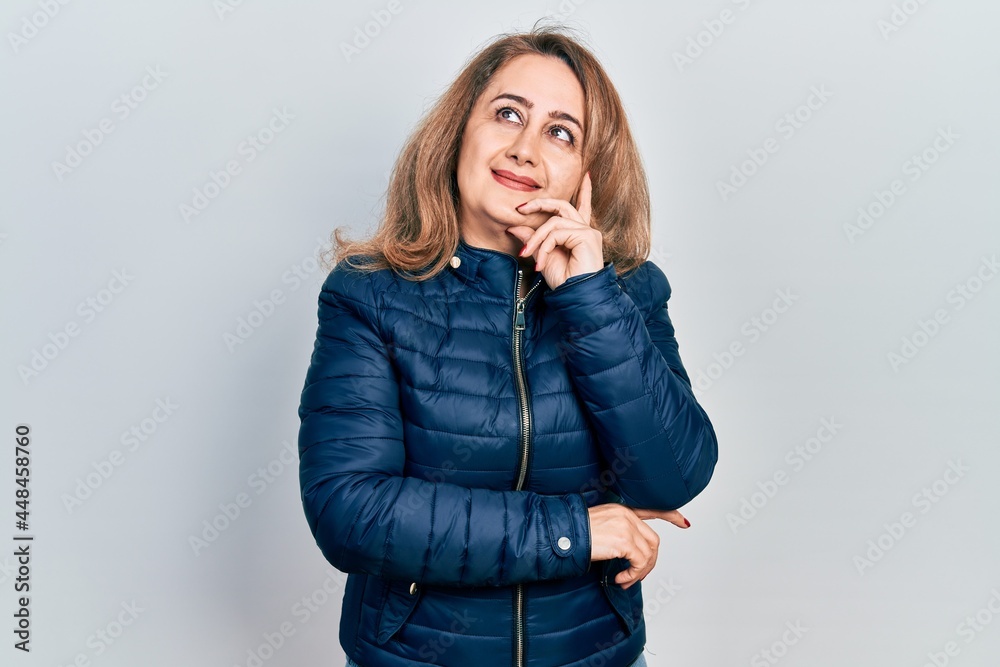 Middle age caucasian woman wearing casual clothes with hand on chin thinking about question, pensive expression. smiling with thoughtful face. doubt concept. Middle age caucasian woman wearing casual clothes with hand on chin thinking about question, pensive expression. smiling with thoughtful face. doubt concept.