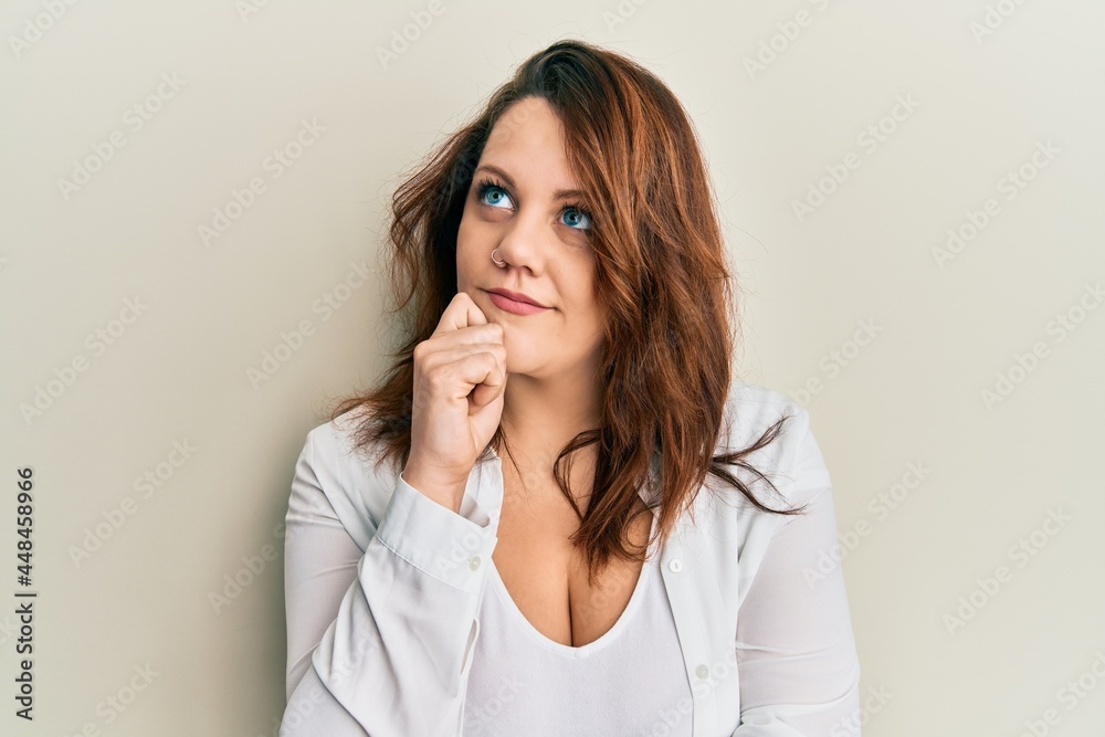 Young caucasian woman wearing casual clothes thinking concentrated about doubt with finger on chin and looking up wondering