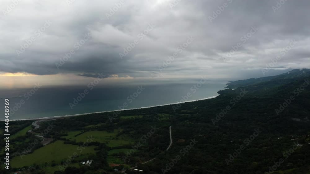 Mountains tropical forest along the pacific ocean aerial hermosa beach Costa Rica cloudy day 
