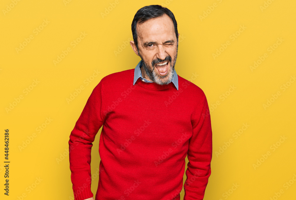Middle age hispanic man wearing casual clothes winking looking at the camera with sexy expression, cheerful and happy face. Middle age hispanic man wearing casual clothes winking looking at the camera with sexy expression, cheerful and happy face.