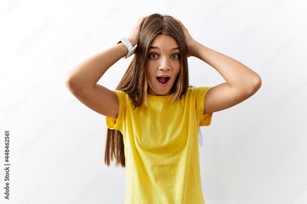 Young brunette teenager standing together over isolated background crazy and scared with hands on head, afraid and surprised of shock with open mouth Young brunette teenager standing together over isolated background crazy and scared with hands on head, afraid and surprised of shock with open mouth