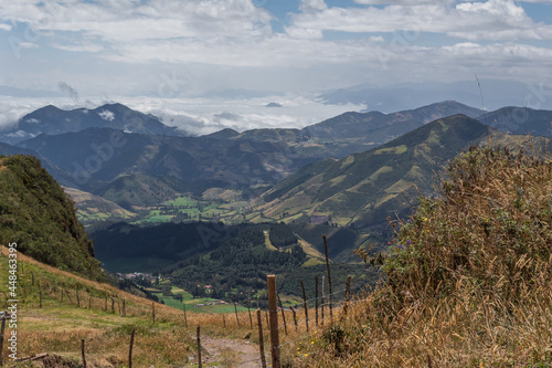 Andean landscape mountains clouds agriculture grass