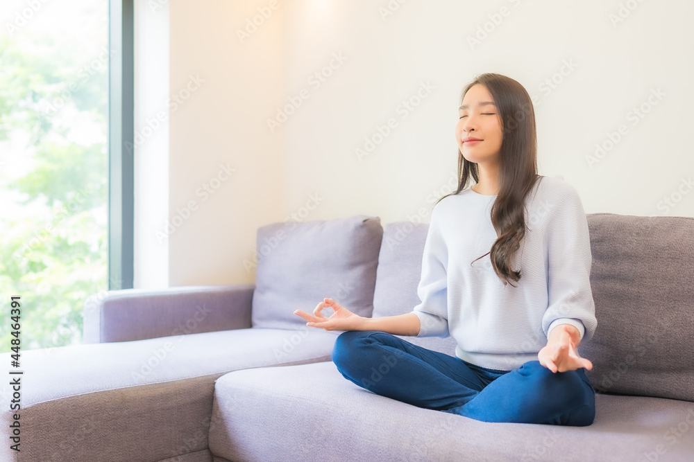Portrait beautiful young asian woman meditation on sofa