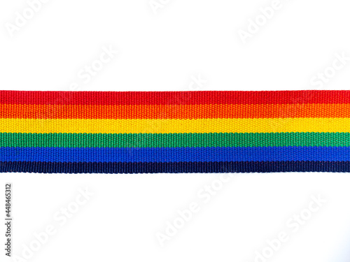 Rainbow stripe ribbon isolated on white background with copy space. LGBT concept with pride colors and rainbow flag strip. LGBT banner background.