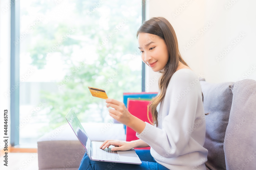 Portrait beautiful young asian woman use laptop credit card for online shopping Portrait beautiful young asian woman use laptop credit card for online shopping