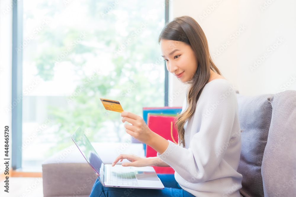 Portrait beautiful young asian woman use laptop credit card for online shopping Portrait beautiful young asian woman use laptop credit card for online shopping