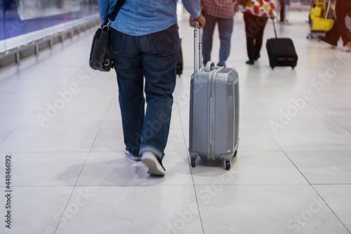 Traveler passenger hold luggage at terminal airport or transit flight with suitcase in journey vacation holiday at arrival international, No people in transportation during covid19 virus pandemic