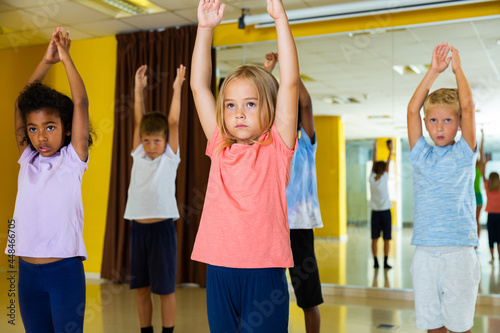 Portrait of smiling children practicing sport dance in modern dance hall. High quality photo