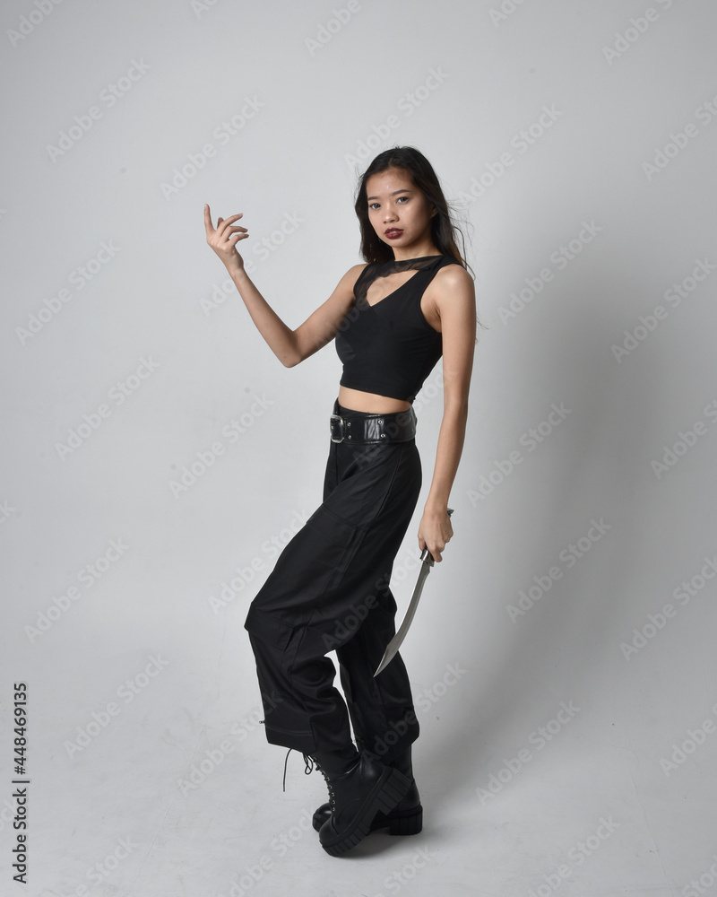 Full length portrait of pretty young asian girl wearing black tank top ...