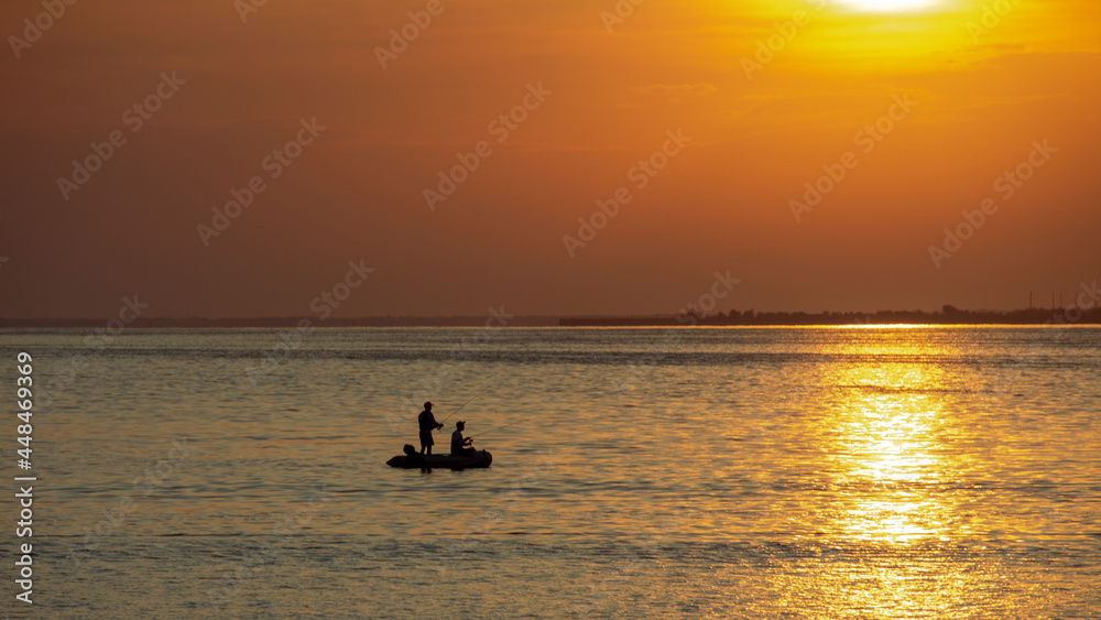 silhouette of rubber boat and golden sunset,Surin Island National park, Thailand