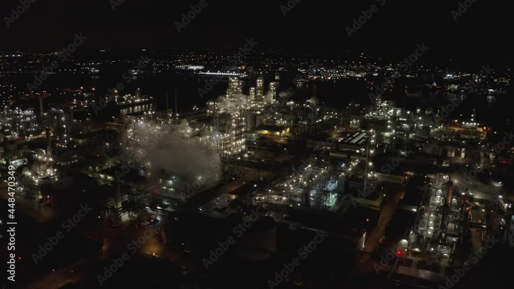 Lights And Smoke From Chemical Plant By The Embankment Of Beneden Merwede River In Dordrecht, Netherlands At Night. aerial Lights And Smoke From Chemical Plant By The Embankment Of Beneden Merwede River In Dordrecht, Netherlands At Night. aerial