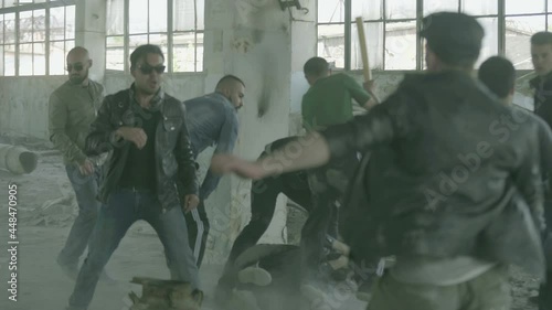 4k Group of men fighting in abandoned building . Friends helping each other during the fight . Drug deal between criminal gangs goes wrong & a fight breaks out .  Staged, scenic shot with artists photo