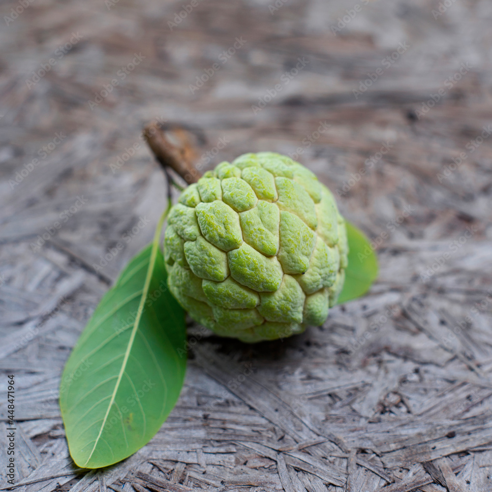 Fototapeta premium Fresh custard apple on wooden background