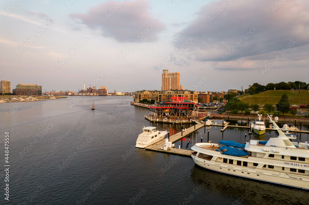 Aerial View of Baltimore City Inner Harbor at Sunset with Boat Passing in the Water