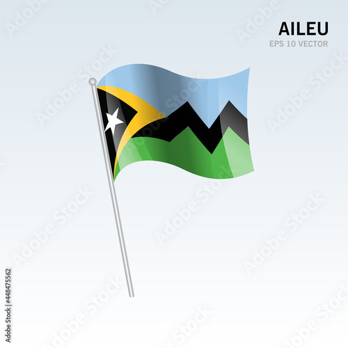 Waving flag of Aileu districts of Timor Leste on gray background photo