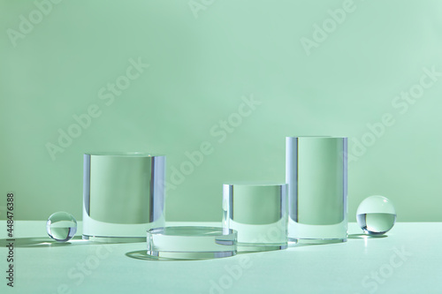 ylinder abstract minimal scene with glass geometric platform. Background  rendering crystal podium. Stand to show cosmetic products. Stage Showcase on pedestal modern studio green pastel. photo