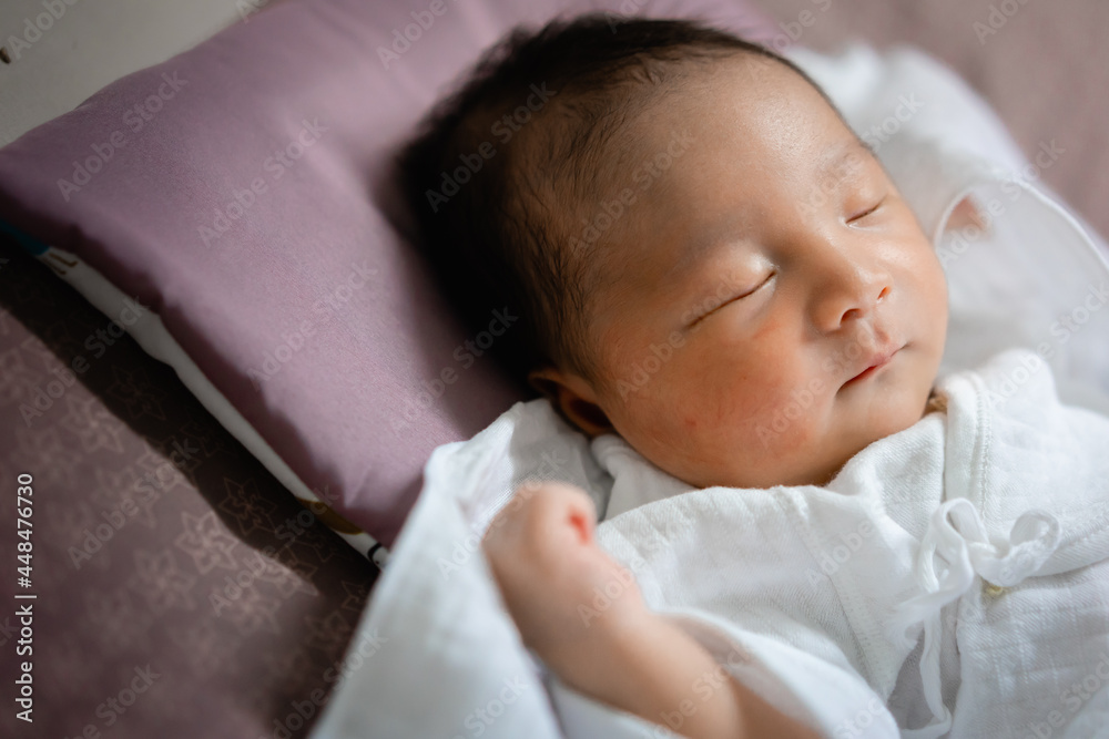 Asian newborn sleeping on bed. New family, protection, relaxation and relationship concepts. Asian newborn sleeping on bed. New family, protection, relaxation and relationship concepts.