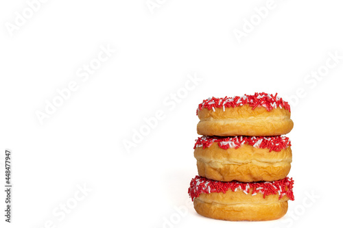 Three red donuts with sprinklers isolated on white background with copy space for text