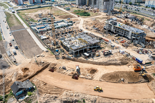 aerial panoramic view of large construction site at sunny summer day. construction of new buildings and urban road. photo