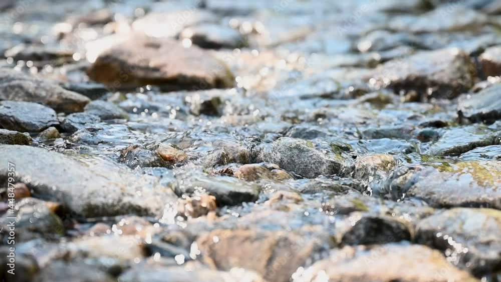 Mountain stream gently flowing over rocks Mountain stream gently flowing over rocks