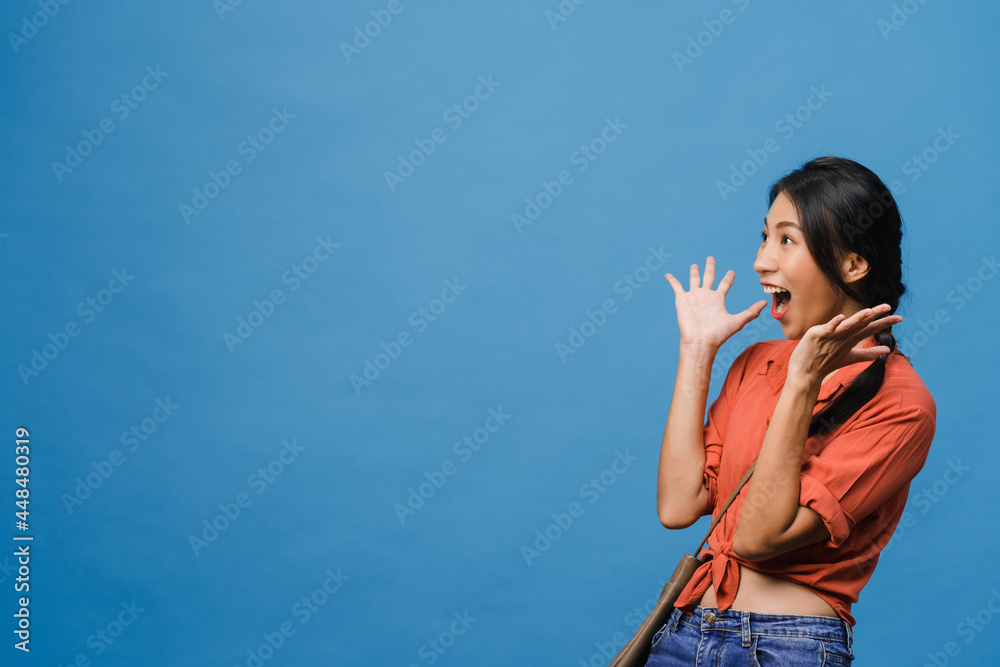 Young Asia lady feel happiness with positive expression, joyful surprise funky, dressed in casual cloth isolated on blue background. Happy adorable glad woman rejoices success. Facial expression. Young Asia lady feel happiness with positive expression, joyful surprise funky, dressed in casual cloth isolated on blue background. Happy adorable glad woman rejoices success. Facial expression.
