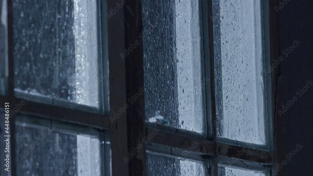 Window glass breaking during bad rainy weather . Plate glass window shattering . Thunder Through The Window . Heavy Rain Drops Sliding Down On Window Glass . Shot on Red Epic camera in slow motion . 